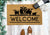 Outdoor doormat with cows and welcome text.