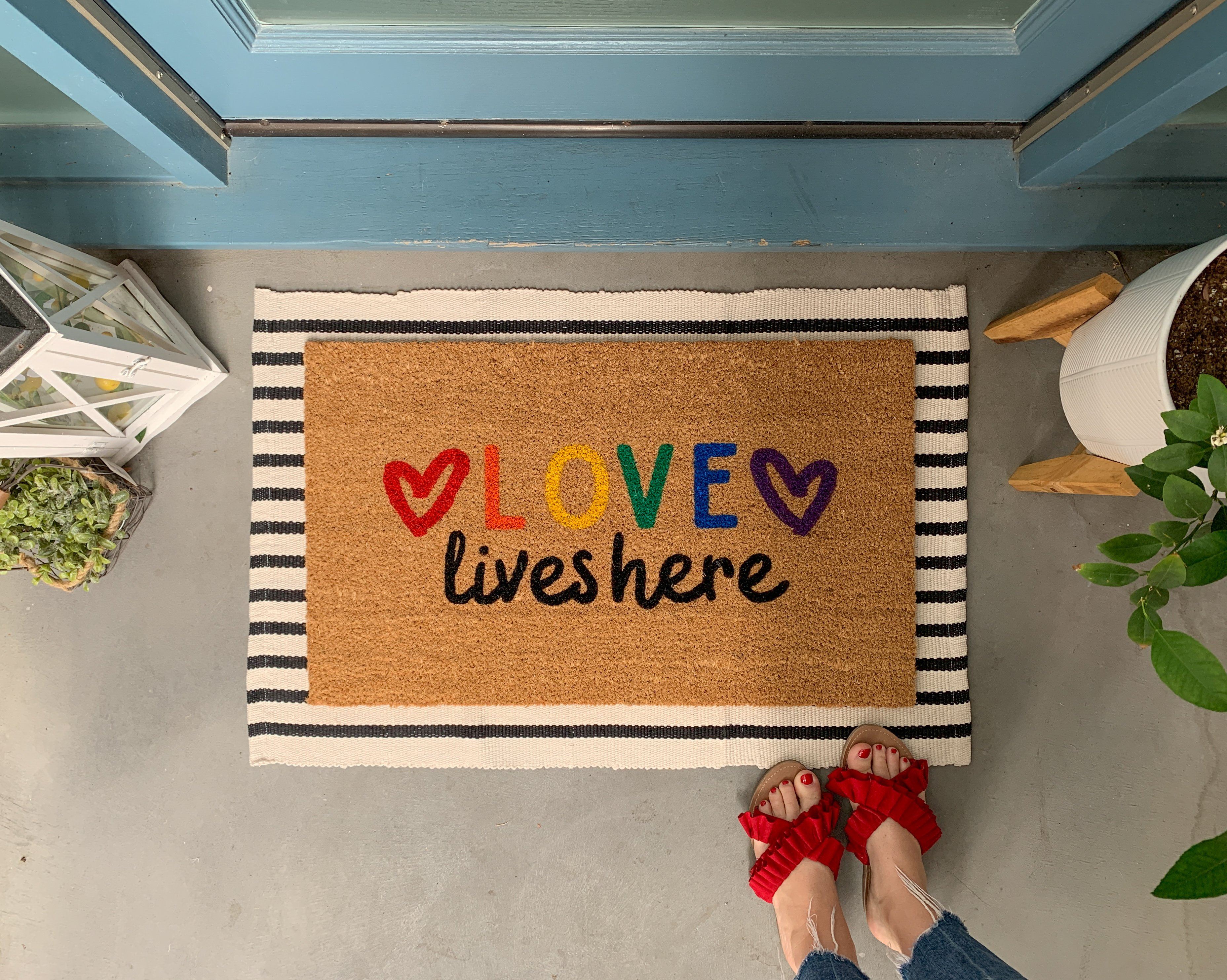 https://nickel-designs.com/cdn/shop/products/doormat-love-lives-here-pride-doormat-5@2x.jpg?v=1624306744